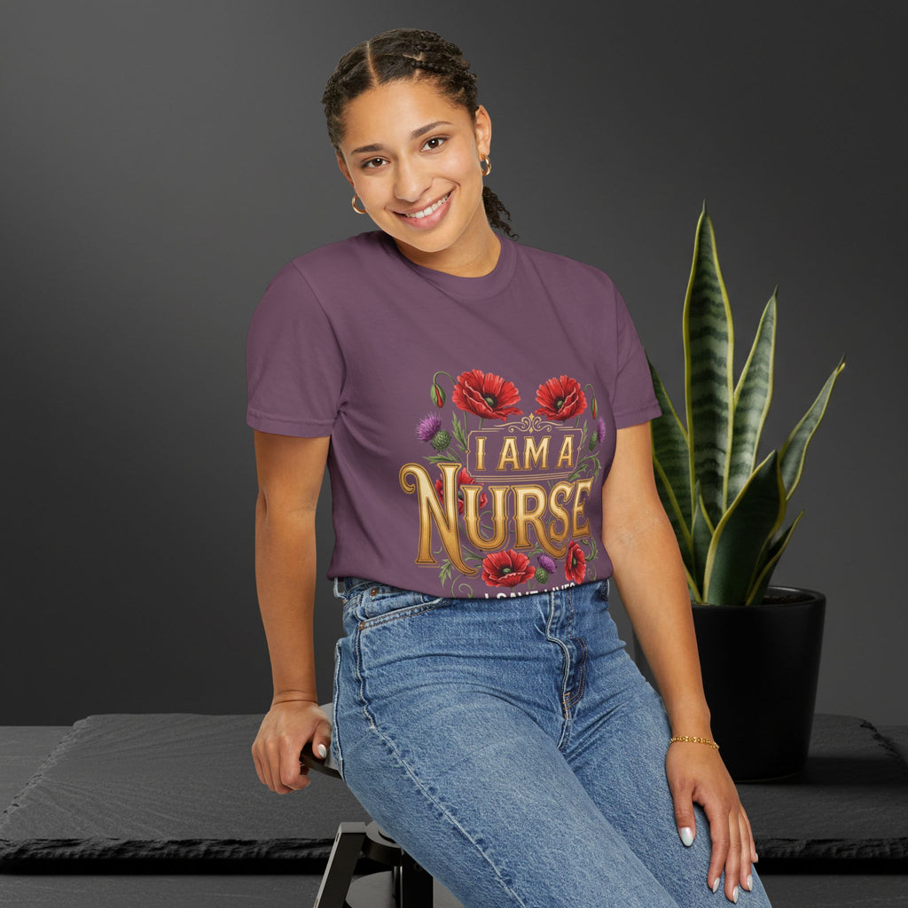 Woman wearing a purple 'I AM A NURSE' t-shirt sitting in front of a plant.