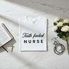 Folded shirt on marble with Bible, cross, flowers, stethoscope