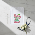 Folded shirt on marble with cross, white flowers, stethoscope